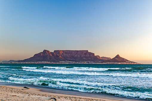 View of Cape Town and Table Mountain from Bloubergstrand and across Table bay at sunset