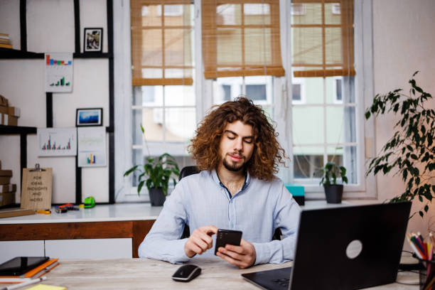 istock Man surfing the net on smartphone in office 1459370879