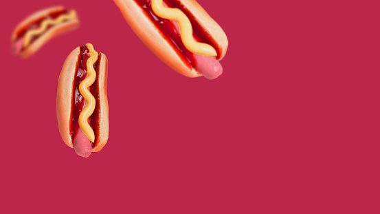 Hot dog isolated on a viva magenta background. Copy space.
