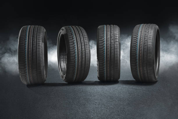 car tires with a great profile on illuminates asphalt, smoke - street fog profile imagens e fotografias de stock