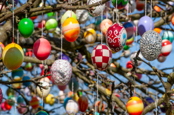 Colorful handmade Eastereggs on an apple tree - easteregg tree stock photo