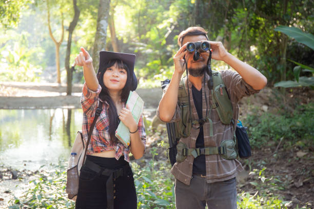 istock Family with father and daughter tourist backpack hiking doing activity while father looking binoculars in holiday together, man and teenager woman journey adventure trip and looking map. 1459375391