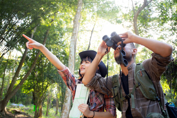 istock Family with father and daughter tourist backpack hiking doing activity while father looking binoculars in holiday together, man and teenager woman journey adventure trip and looking map. 1459376287