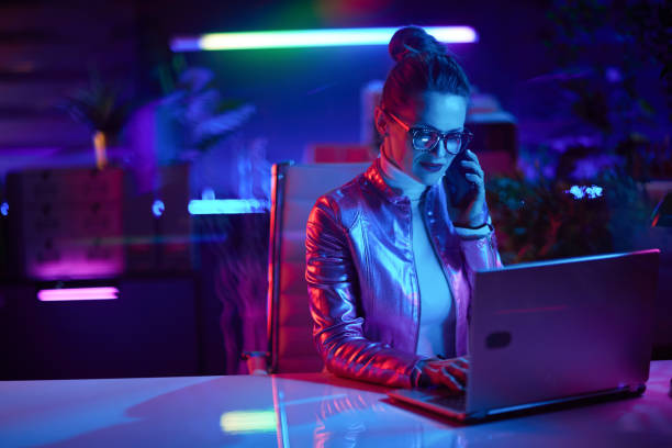 istock stylish business woman using laptop and using smartphone 1459377163