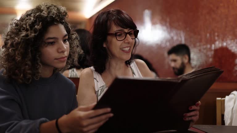 Women in a restaurant reading the menu