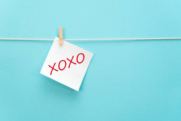 White sticker on a rope with a clothespin with an inscription