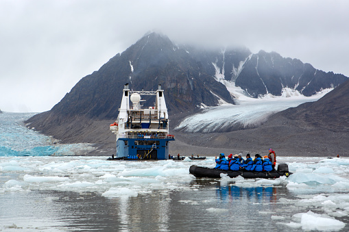 September 4, 2022 -  Svalbard.  visitors view glaciers from zodiacs and witness a calving event.