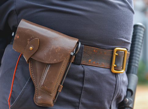 Formation of the Russian police squad rear view, side view. A policeman with a pistol holster, handcuffs, a taser and a holster.A law enforcement officer wears a duty belt, with a pistol, handcuffs.