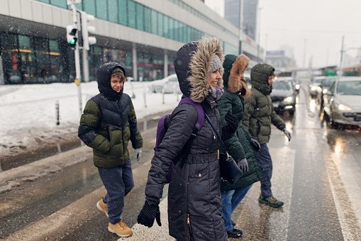 Family off-season winter city break in Warsaw Poland. Mother and three teenagers are walking in the center of Warsaw.
Canon R5