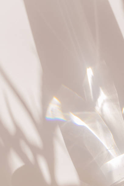 istock Sunlight background, abstract backdrop with light and shadow, glare and shine on paper texture, rainbow flare, beige color trend aesthetic wallpaper. Natural beams light, caustics effect 1459384227