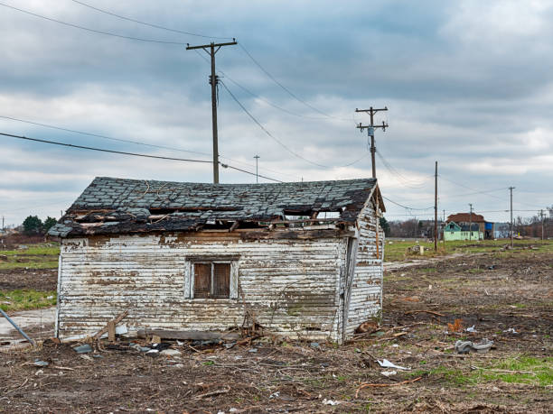 Clearing For Urban Renewal One small building remains standing in a residential neighborhood that is being demolished for an urban renewal project. highland park michigan stock pictures, royalty-free photos & images