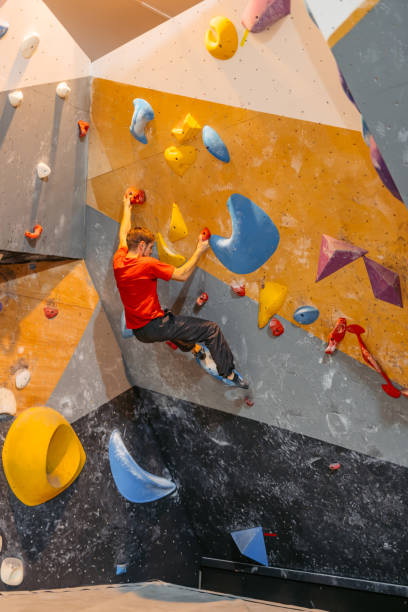 istock Young Man Climbing On A Climbing Wall 1459385401