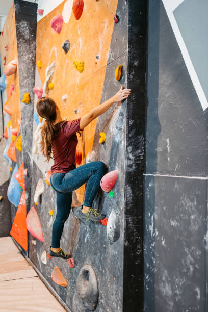 istock Young Woman Climbing On A Climbing Wall 1459385698