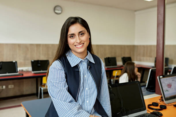 Portrait of early 30s school teacher in computer lab