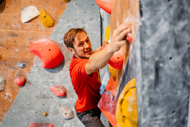 istock Young Man Climbing On A Climbing Wall 1459385853