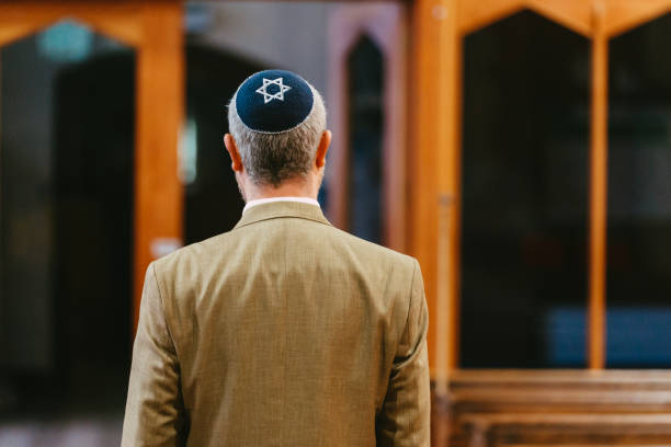 istock Jewish man wearing yarmulke in synagogue 1459385879