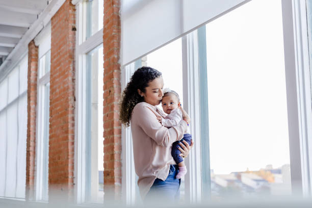 istock Young mother kisses her baby 1459386055