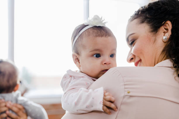 istock Young daughter looks over mother's shoulder 1459386063