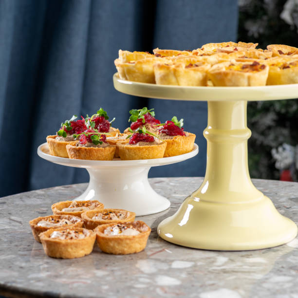 istock Tartlets stuffed with codfish liver, codfish caviar and microgreens. Traditional cold portioned appetizer in a pastry basket. 1459386617