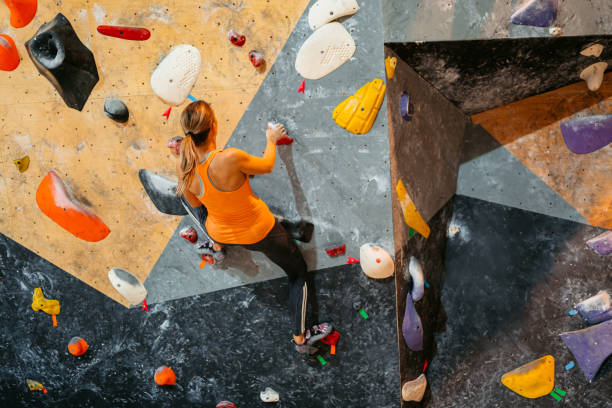 istock Young Woman Climbing On A Climbing Wall 1459386798
