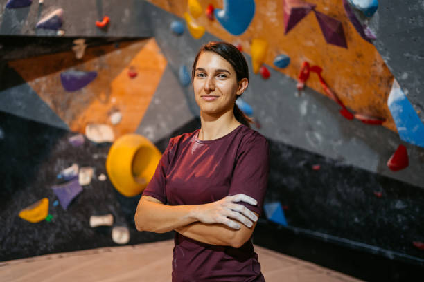 istock Young Female Climber In Front Of A Climbing Wall 1459388215