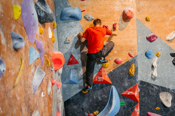 istock Young Man Climbing On A Climbing Wall 1459388399