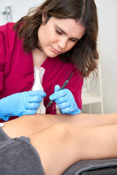 istock Therapist performing a percutaneous electrolysis procedure with an ultrasound machine on the knee. 1459388447