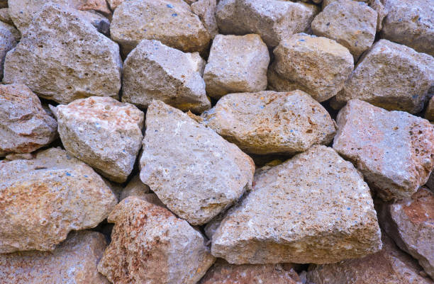 istock Texture of a stone wall. Old castle stone wall texture background. Brown, sienna large stones. Part of a stone wall, for background or texture 1459388522