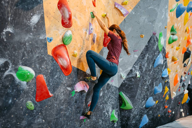 istock Young Woman Climbing On A Climbing Wall 1459388588