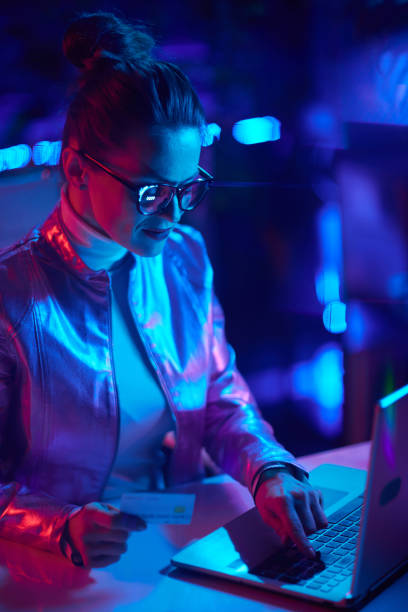 istock modern woman in glasses with credit card using laptop 1459389841