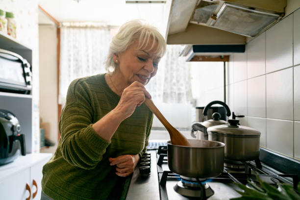 istock Senior woman cooking at home 1459390939