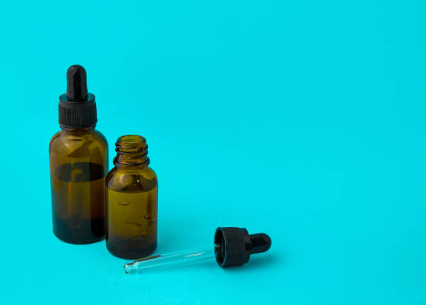 istock Glass vials and a pipette on a blue background. 1459391839