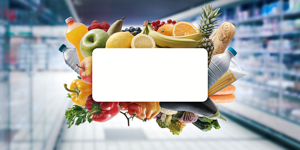 Blank copy space surrounded by fresh groceries and supermarket aisle in the background