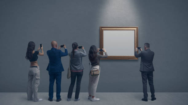 People taking pictures of a painting stock photo