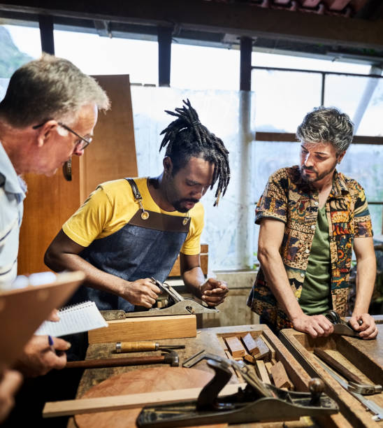 istock Young carpenter showing how to use metal planer in woodworking class 1459392556