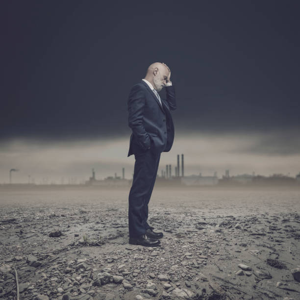 istock Businessman in a dry polluted land 1459394179