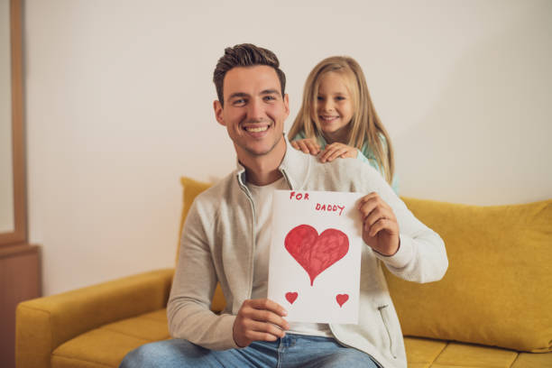 istock Father and daughter with  greeting card 1459394823