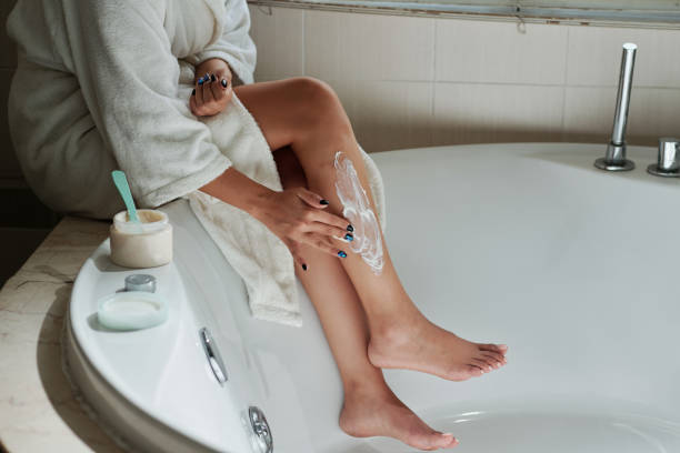 istock Woman Removing Hair from Legs 1459396499