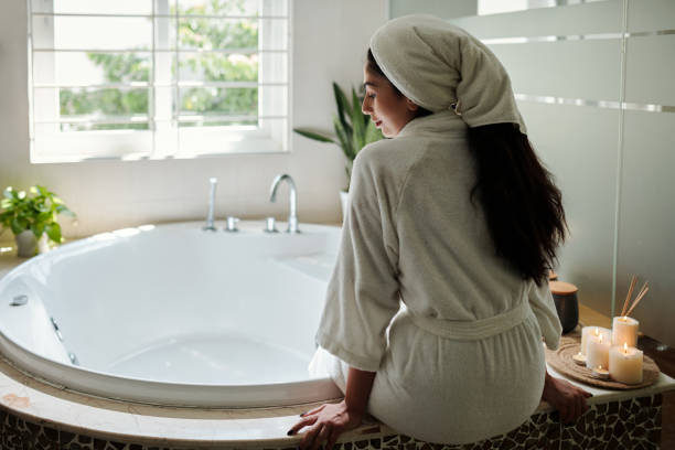 istock Woman Sitting next to Bathtub 1459396558