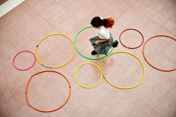 Young student playing hopscotch during recreation break
