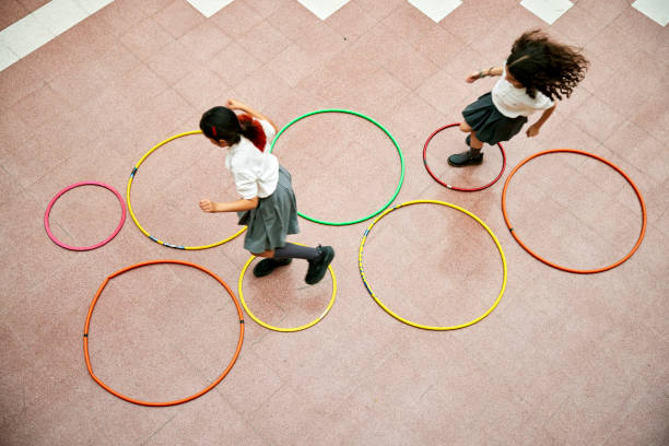 istock Two elementary schoolgirls playing hopscotch 1459399608