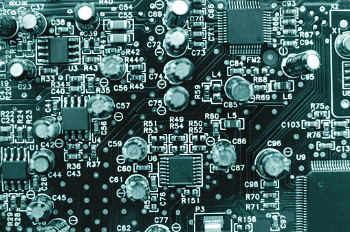 Electronic circuit board with microchips, resistors, semiconductors as background