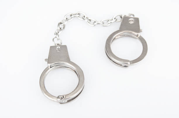 Metal handcuffs on a white background