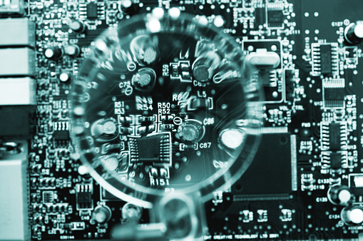 Electronic circuit board under magnifying glass