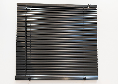 metallic greyish black blind closed in front of the window for modern background line