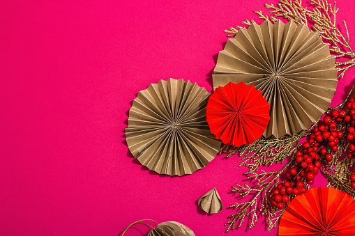Lunar Chinese New Year concept. Oriental asian style paper fans, traditional decor, minimal concept, flat lay. Hard light, dark shadow, trendy viva magenta color background, top view