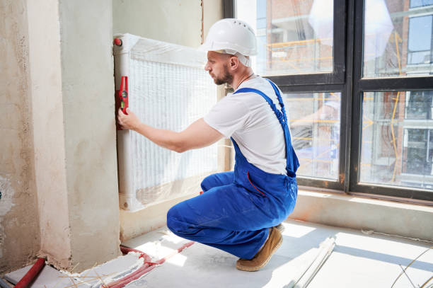 istock Man checking heating radiator with spirit level tool at home. 1459405870