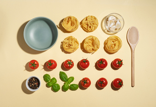 Vegan pasta ingredients  with cherry tomatoes, basil and garlic -  knolling concept