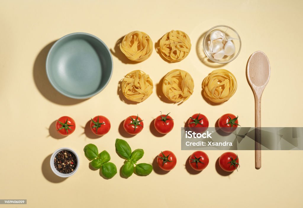 Vegan pasta ingredients  with cherry tomatoes, basil and garlic -  knolling concept Knolling - Concept Stock Photo