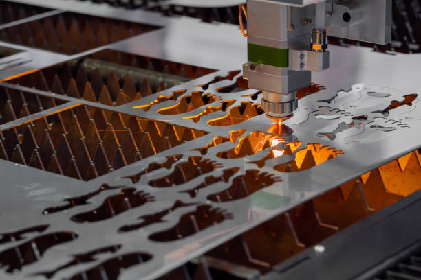 Laser cutting machine working with sheet metal with sparks Automatic cnc laser cutting machine working with sheet metal with many sparks at factory, plant. Metalworking, technology, industrial, manufacturing and equipment concept laser cutting metal stock pictures, royalty-free photos & images
